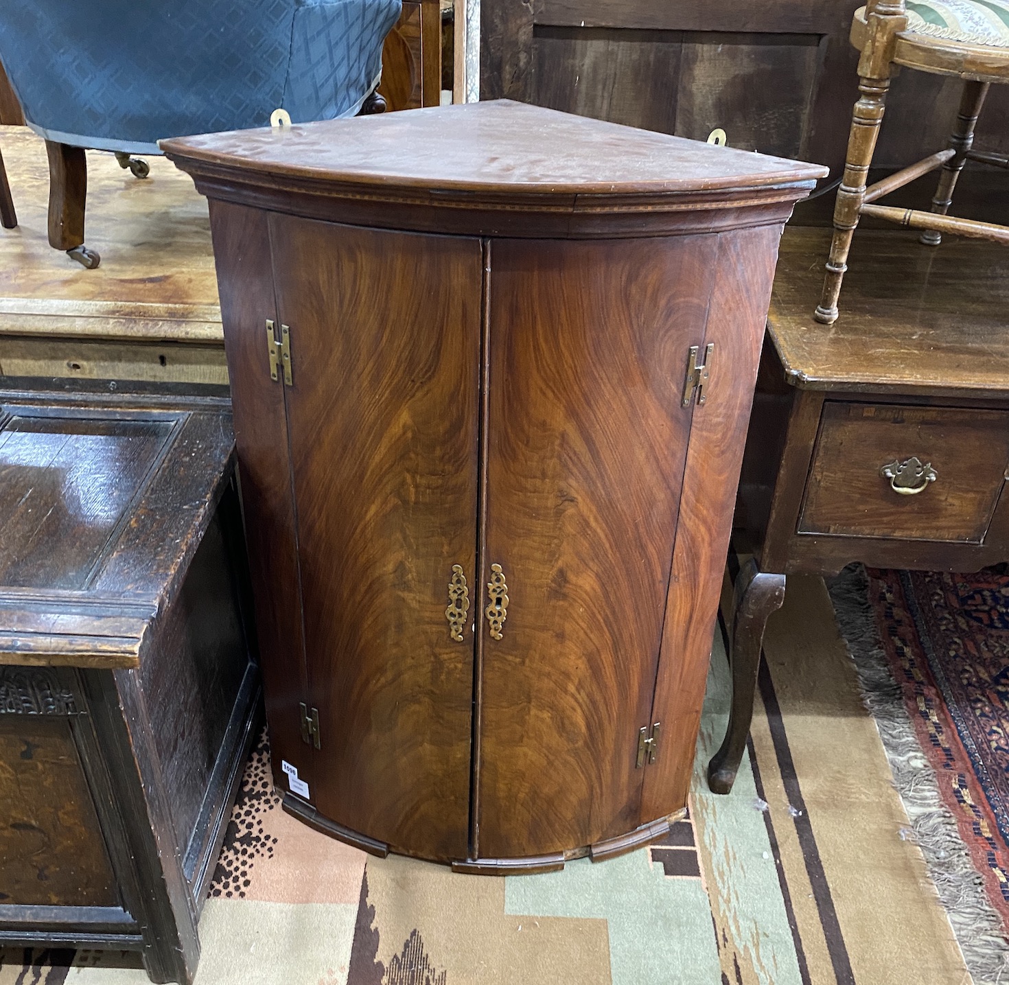 A George III mahogany bow front hanging corner cupboard, width 74cm, depth 47cm, height 105cm